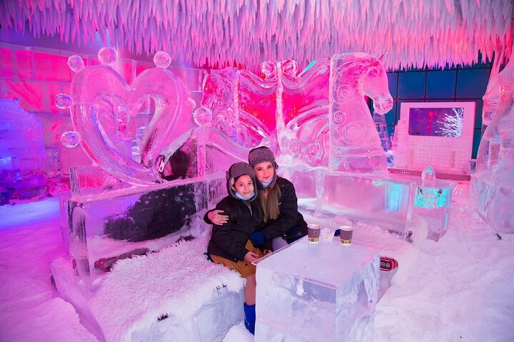 Experience a winter wonderland in the desert where intricate ice sculptures cozy thermal gear and delightful hot drinks create a unique dining adventure unlike any other.
